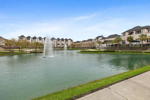 a view of a white house with a swimming pool