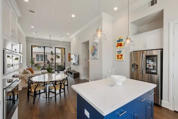 a large kitchen with a table and chairs