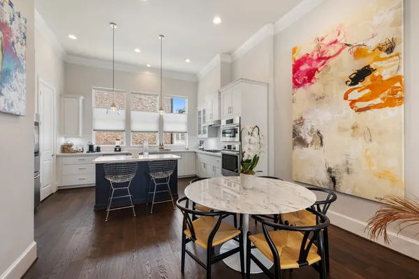 a kitchen with a table and chairs in it