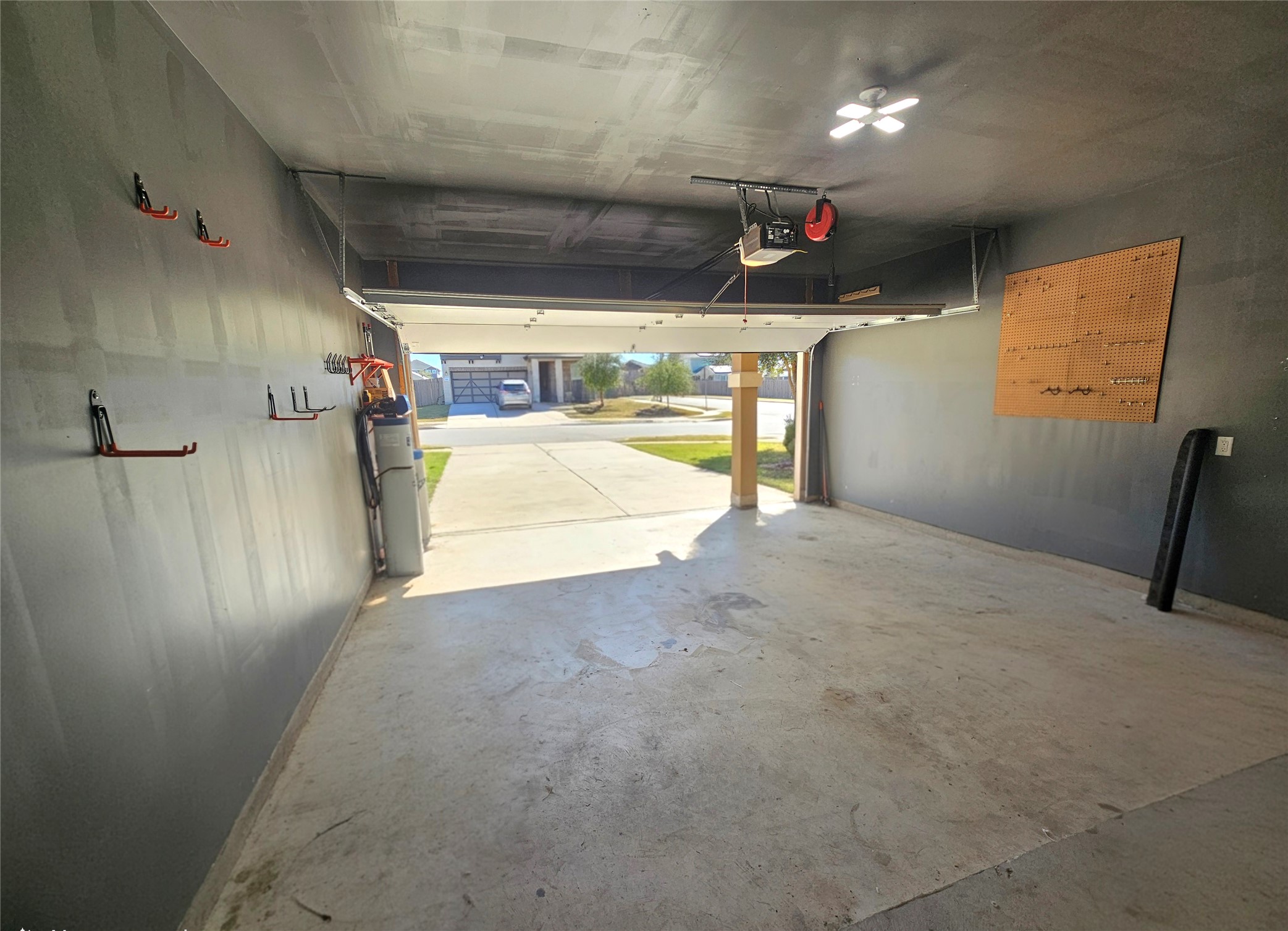 120 Schuylerville Drive Elgin, TX 78621 - Photo 28 of 29 Garage with baseboards and a garage door opener