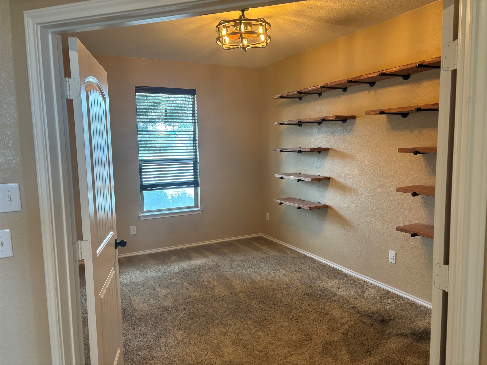 120 Schuylerville Drive Elgin, TX 78621 - Photo 4 of 29 Spare room featuring dark colored carpet and baseboards