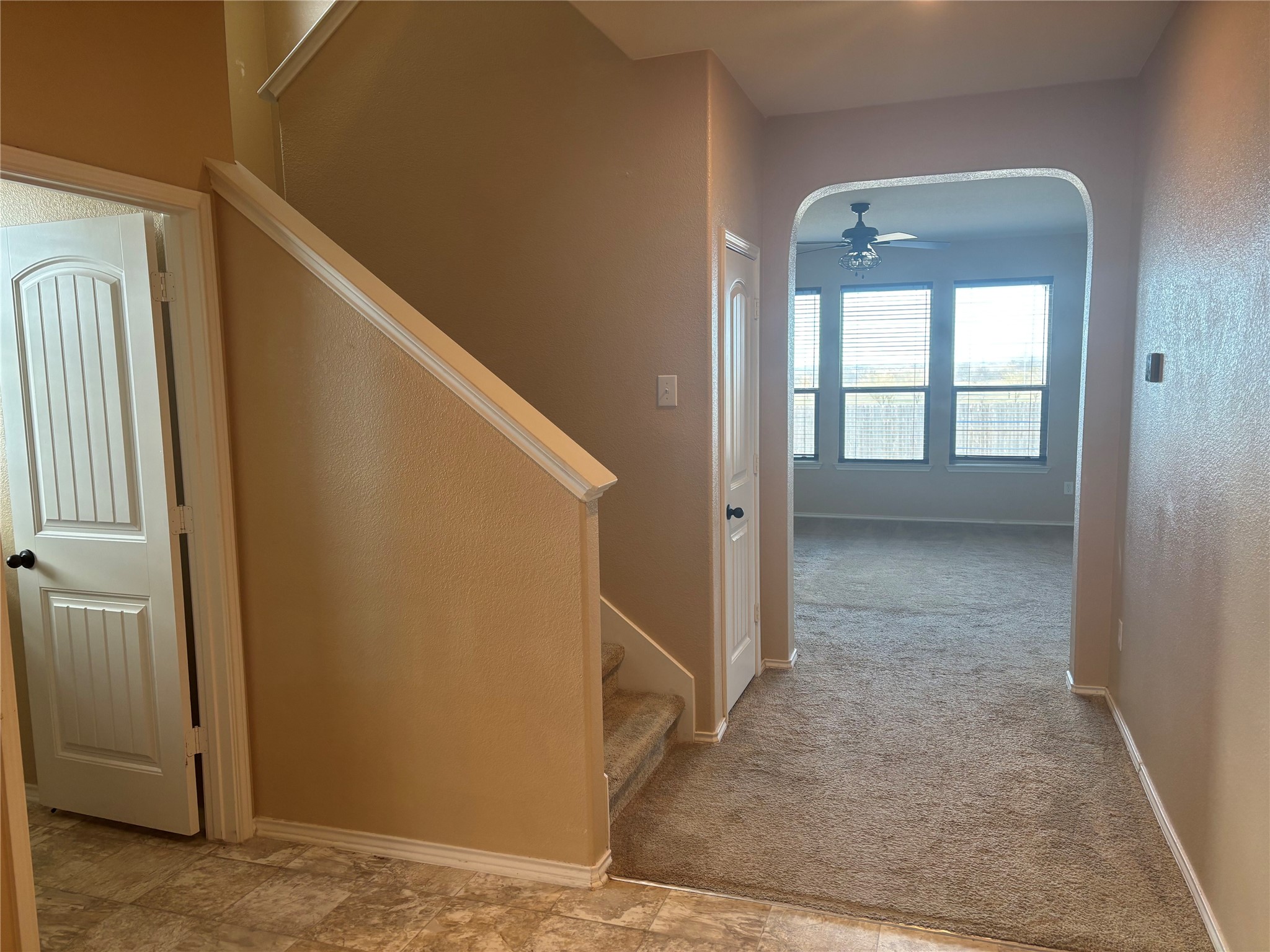 120 Schuylerville Drive Elgin, TX 78621 - Photo 6 of 29 Staircase featuring arched walkways, carpet floors, and ceiling fan