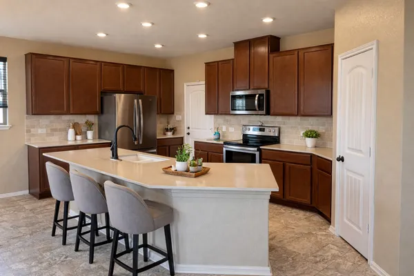 a kitchen with stainless steel appliances granite countertop a refrigerator sink and cabinets