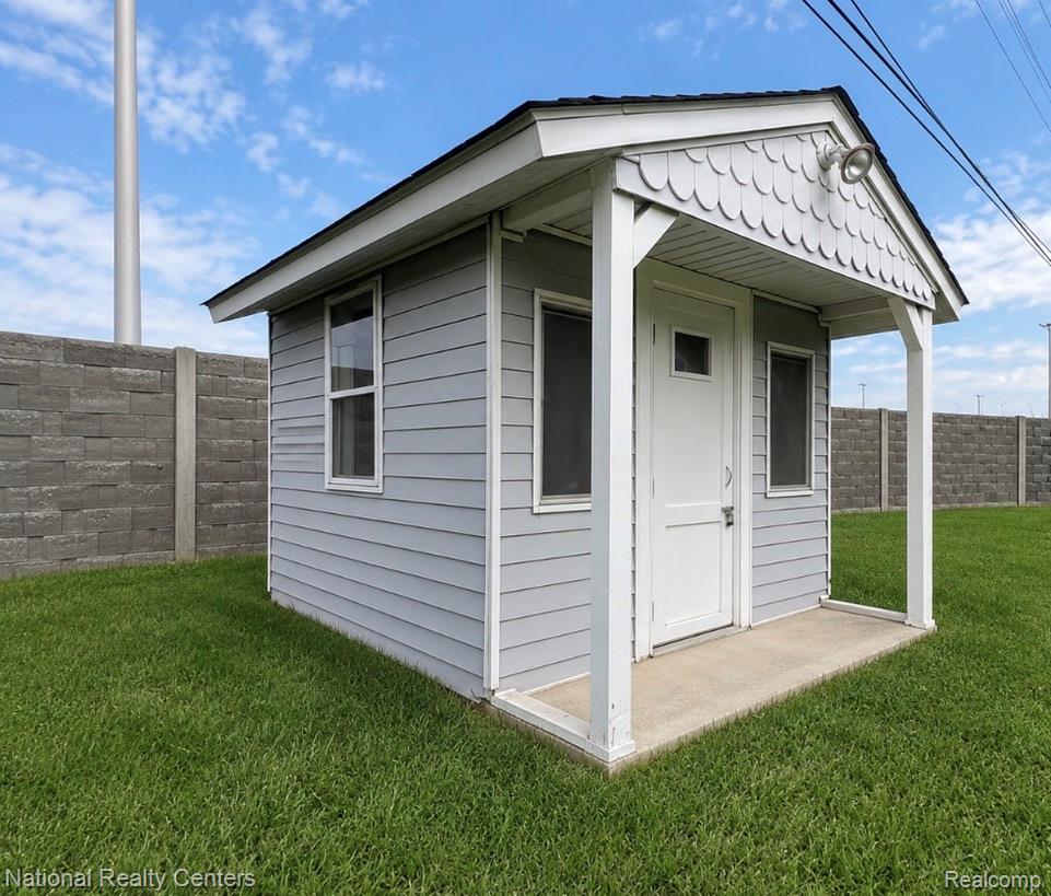 7285 Helen Street Center Line, MI 48015 - Photo 31 of 32 Detached auxiliary structure featuring light gray horizontal siding, an asphalt shingle roof, and white trim