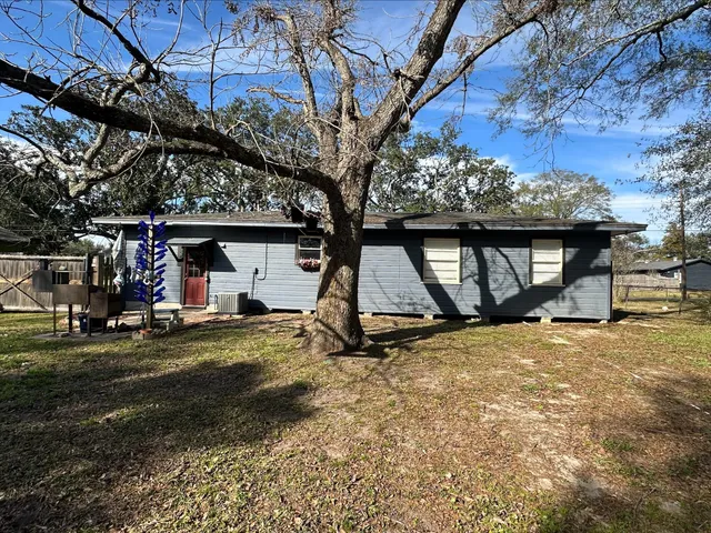 a view of a barn with wooden fence and a bench