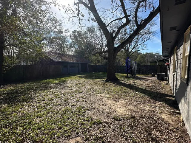a view of a yard with a tree