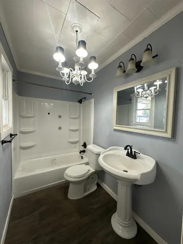 a bathroom with a sink toilet a mirror and bathtub