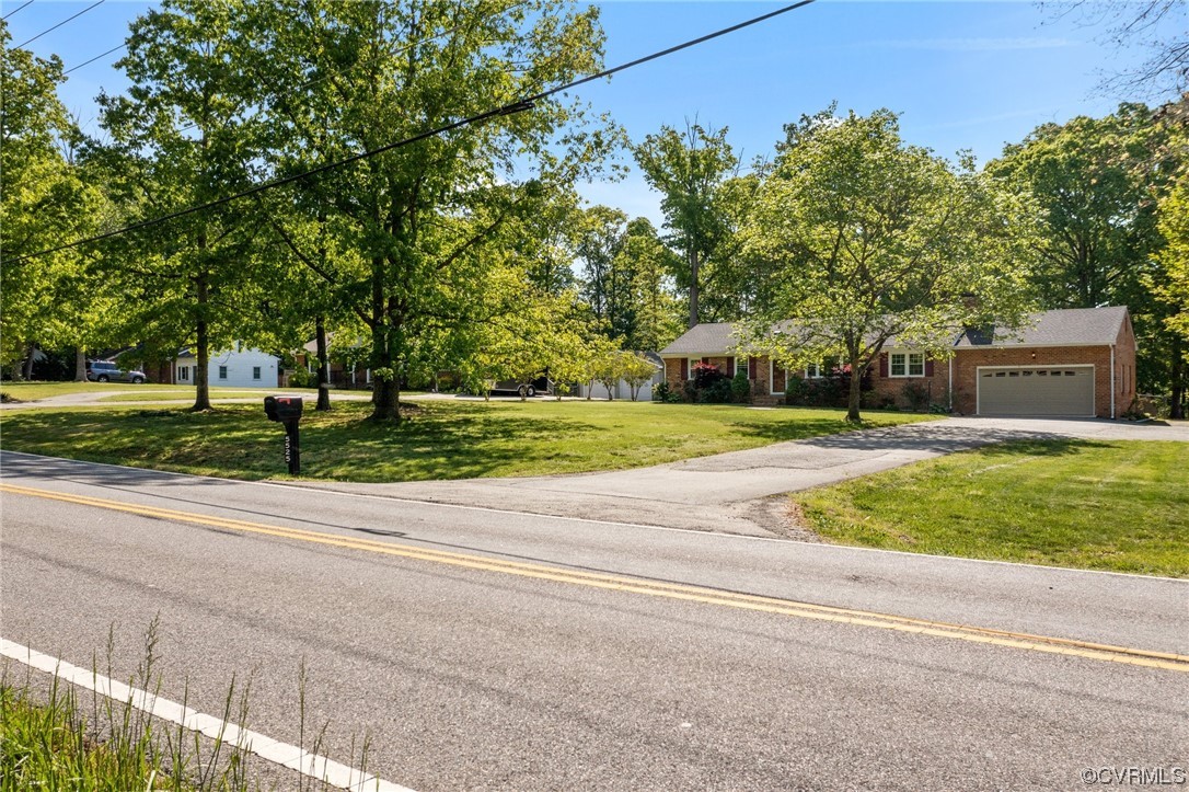 5525 Qualla Road Chesterfield, VA 23832 - Photo 5 of 50 a view of a house with a big yard and large trees