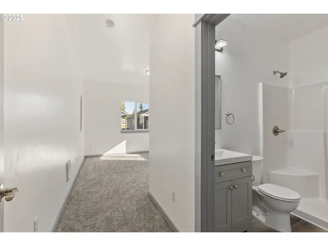 a bathroom with a toilet a sink and shower