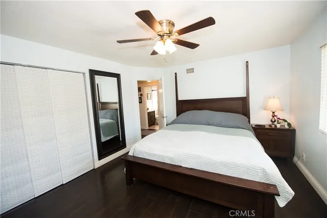 a living room with furniture a flat screen tv and a floor to ceiling window