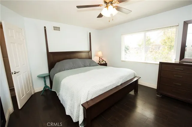 a living room with furniture a flat screen tv and a floor to ceiling window