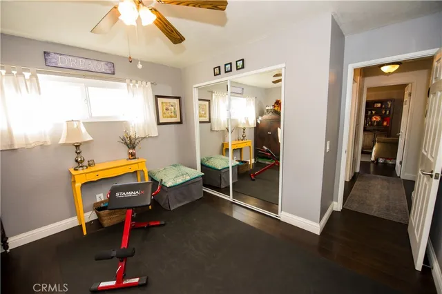 a view of a house with floor to ceiling window and potted plants