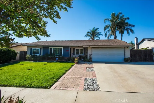 a living room with furniture a fireplace and a large window
