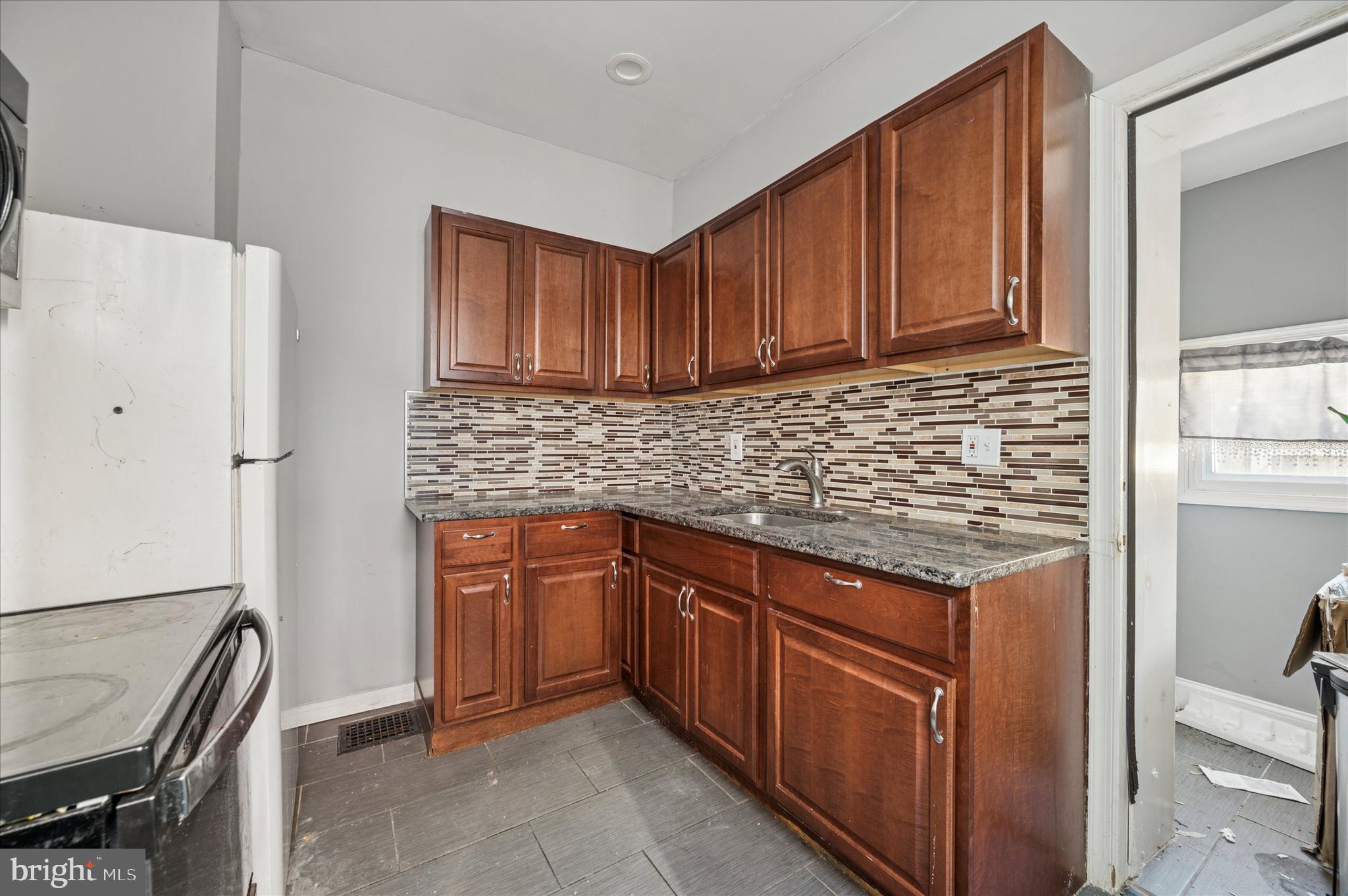 809 East Locust Avenue Philadelphia, PA 19138 - Photo 16 of 23 a kitchen with stainless steel appliances granite countertop a sink stove and refrigerator