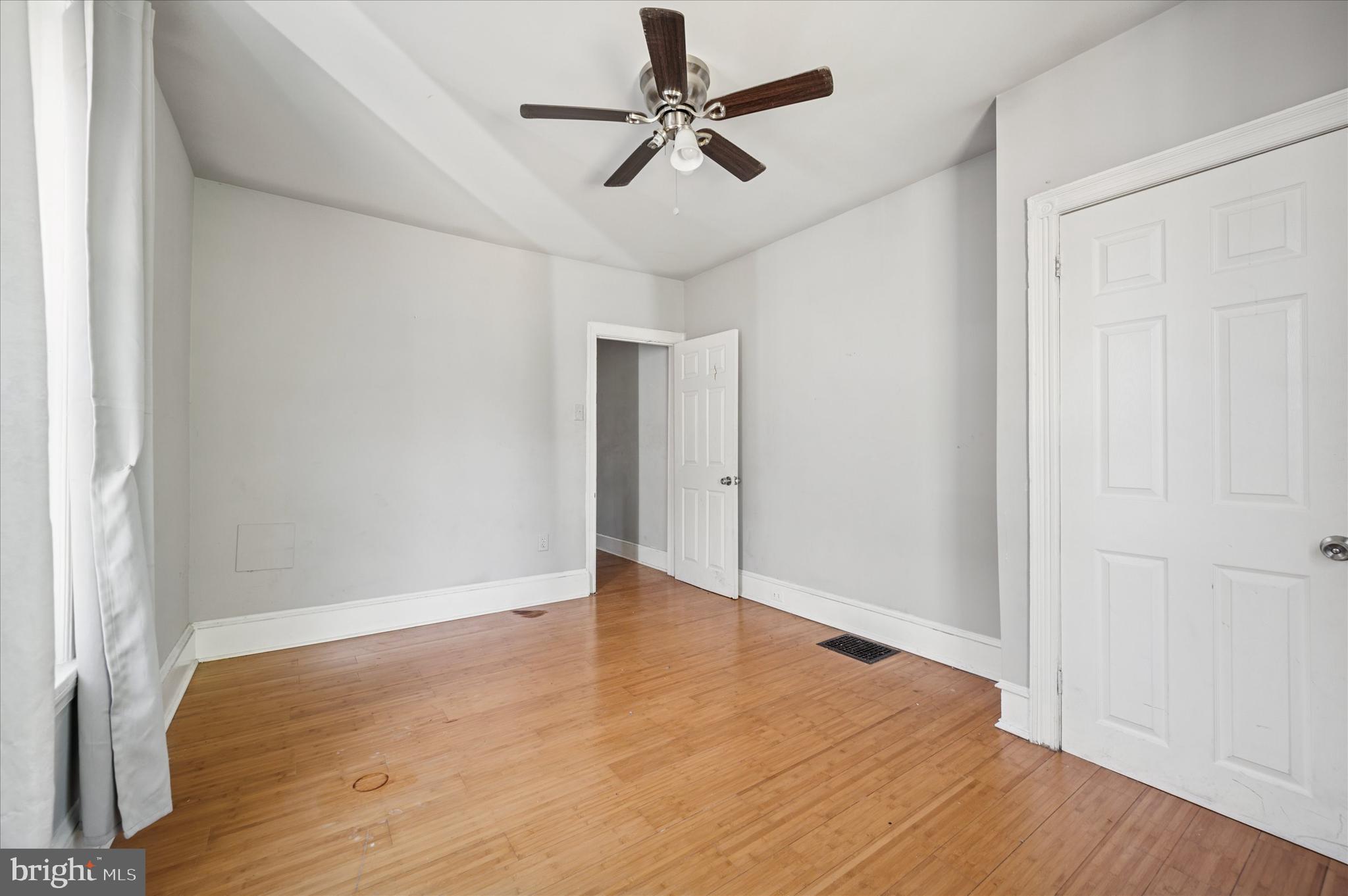 809 East Locust Avenue Philadelphia, PA 19138 - Photo 20 of 23 an empty room with wooden floor and ceiling fan
