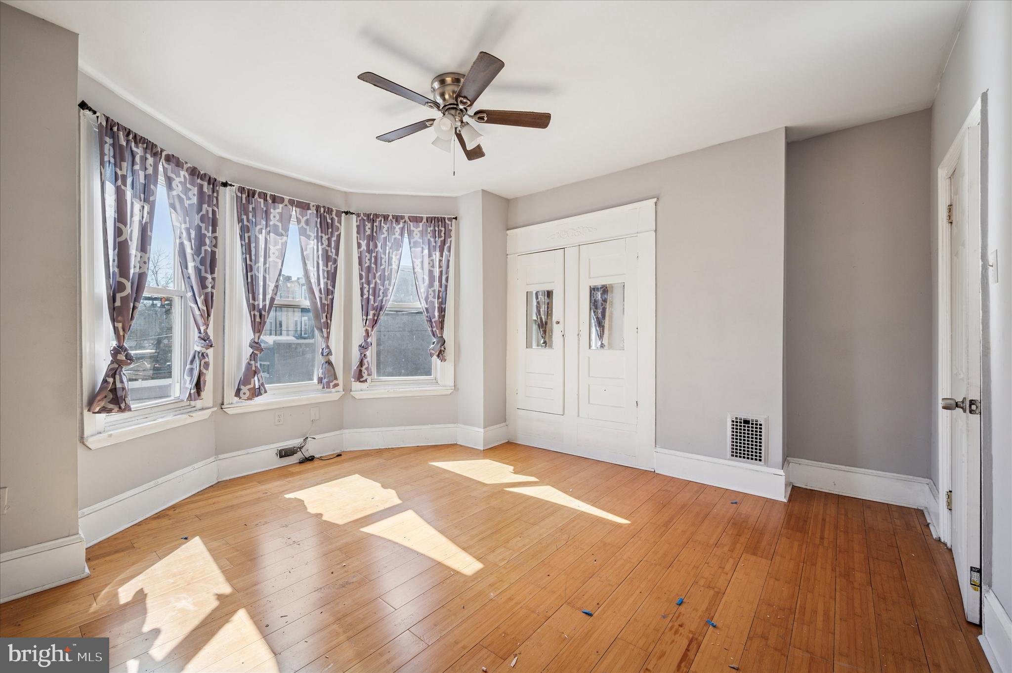 809 East Locust Avenue Philadelphia, PA 19138 - Photo 23 of 23 a view of an empty room with a window and wooden floor