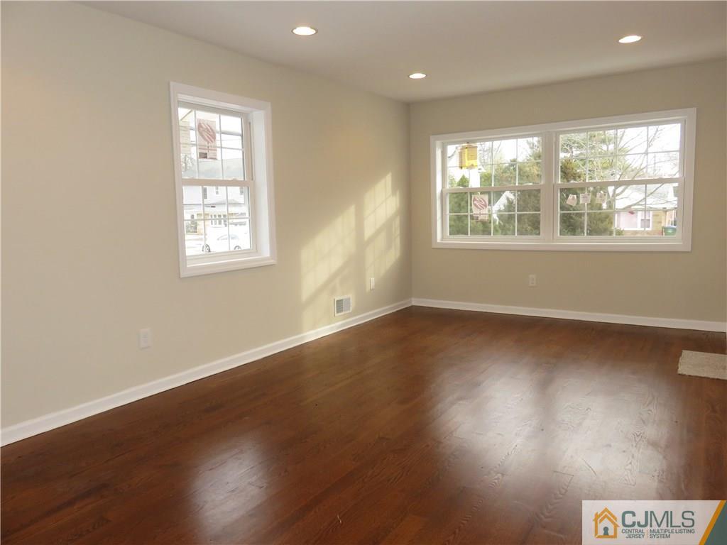 12 Gurley Road Edison, NJ 08817 - Photo 3 of 13 an empty room with wooden floor and windows