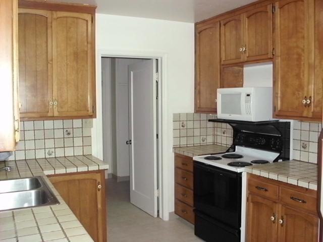 3045 Henderson Road Redding, CA 96002 - Photo 8 of 19 a kitchen with a stove and a refrigerator