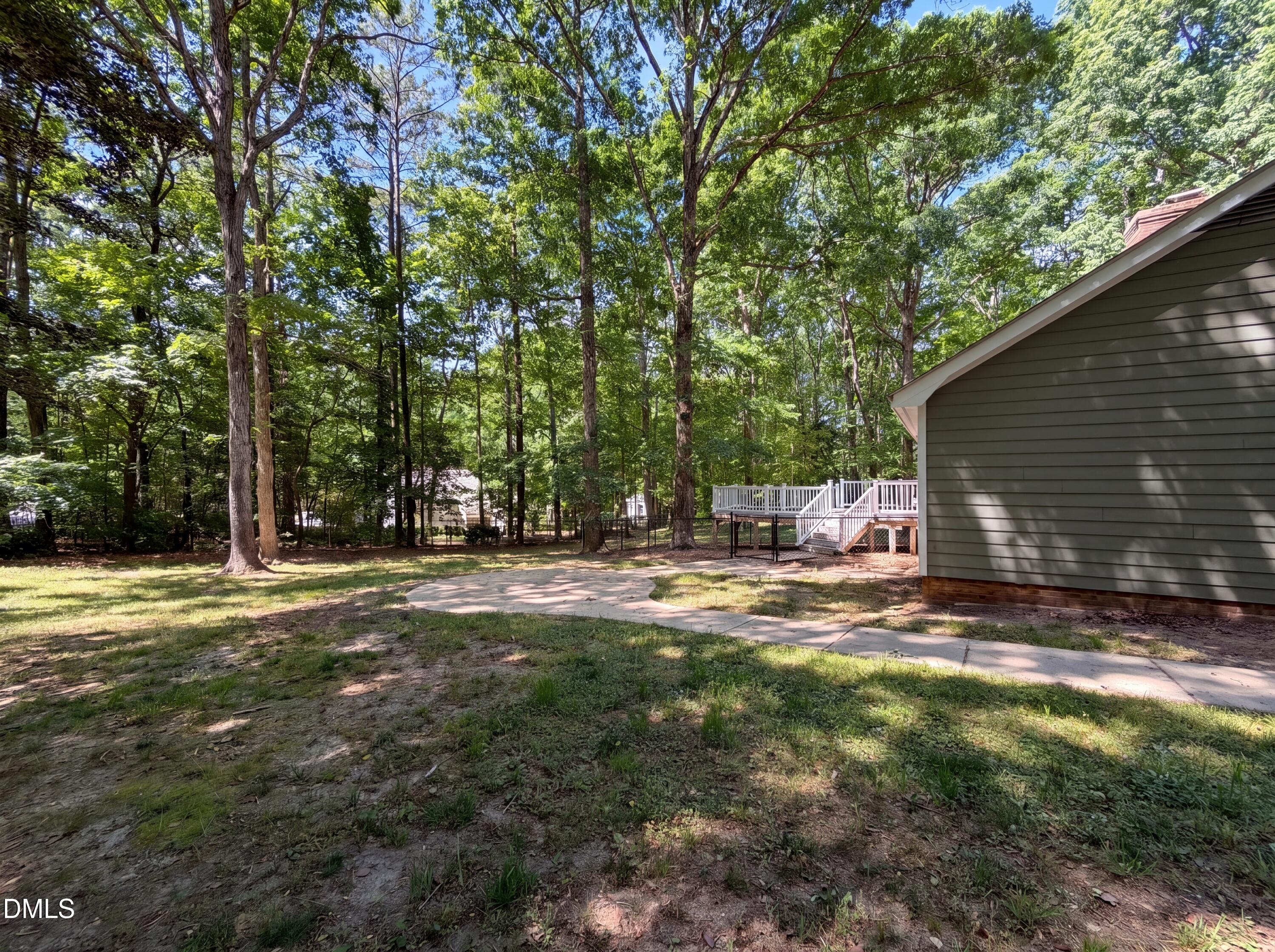 102 Lakeside Farm Road Zebulon, NC 27597 - Photo 17 of 18 a view of a backyard with large trees