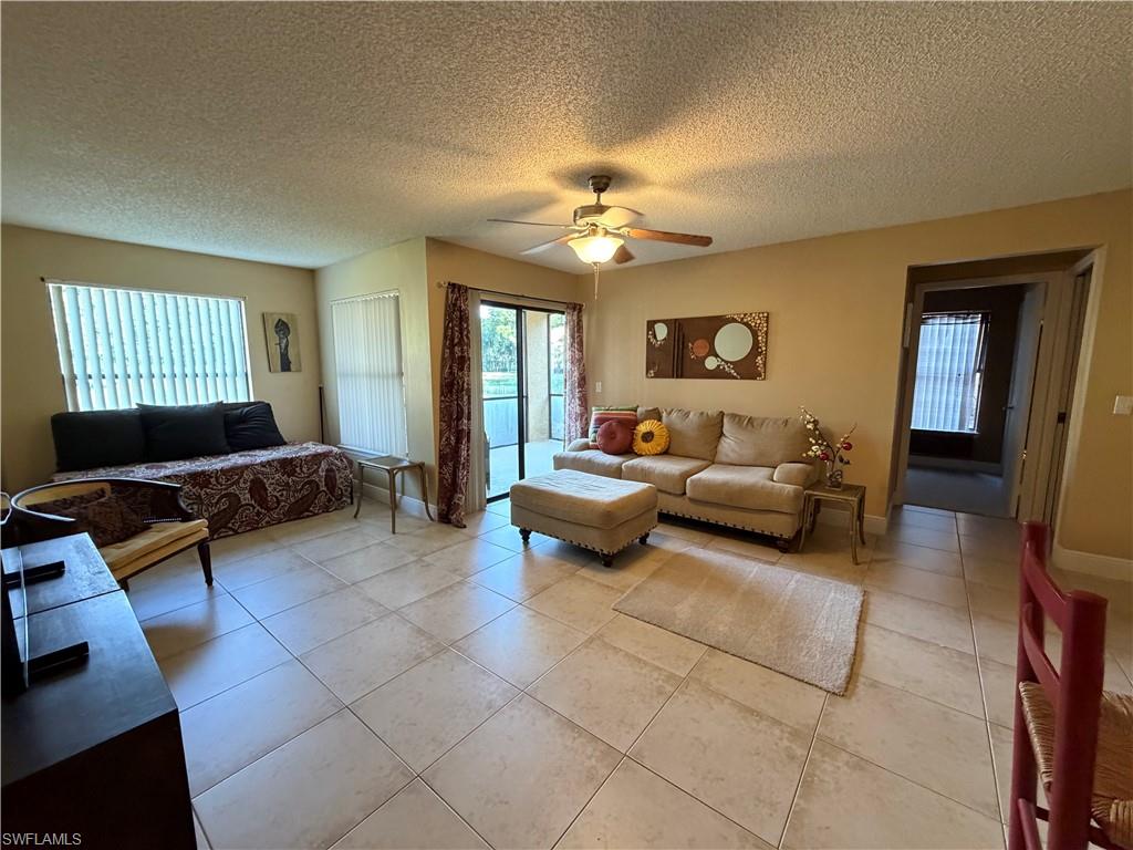 2070 Arbour Walk Circle, Unit 3214 Naples, FL 34109 - Photo 2 of 12 a living room with furniture and a chandelier