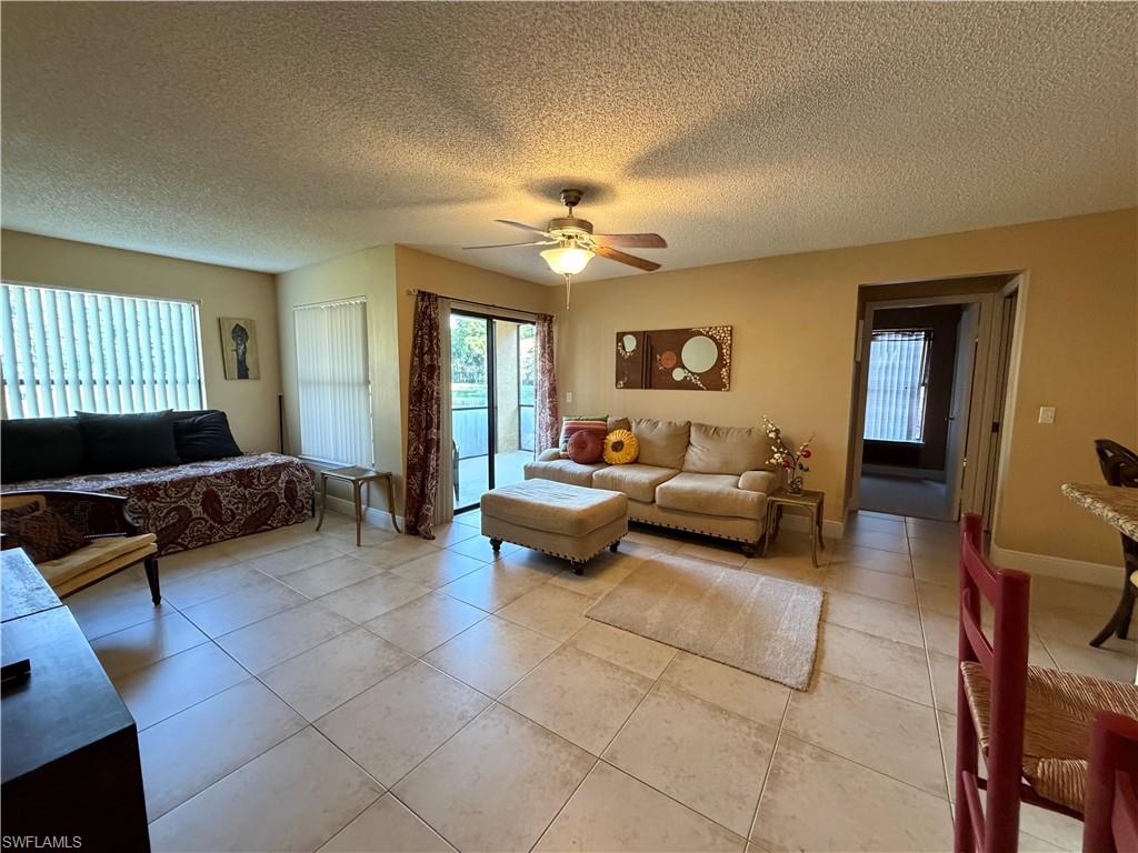 2070 Arbour Walk Circle, Unit 3214 Naples, FL 34109 - Photo 3 of 12 a bedroom with furniture and a chandelier