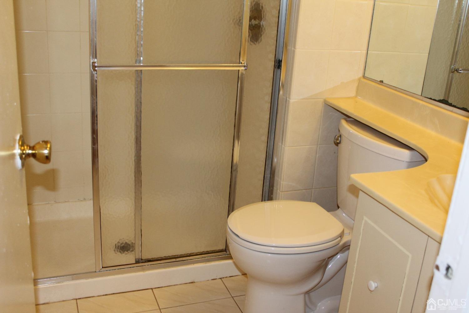 157 Westgate Drive Edison, NJ 08820 - Photo 12 of 40 a bathroom with a toilet and a shower