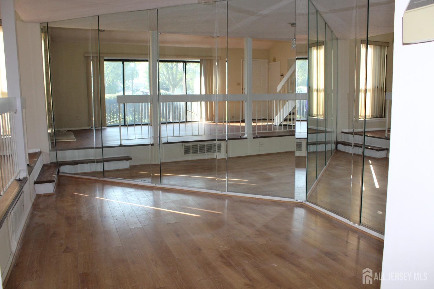 157 Westgate Drive Edison, NJ 08820 - Photo 19 of 40 a view of empty room with wooden floor and fan