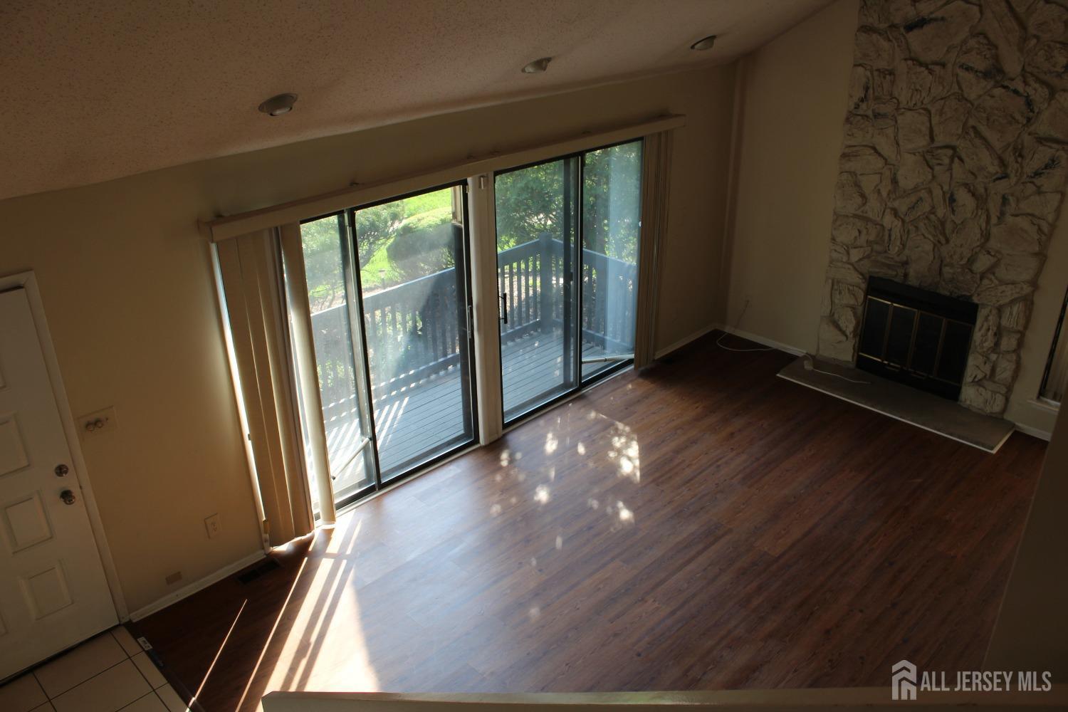 157 Westgate Drive Edison, NJ 08820 - Photo 25 of 40 a view of an empty room with wooden floor and a window