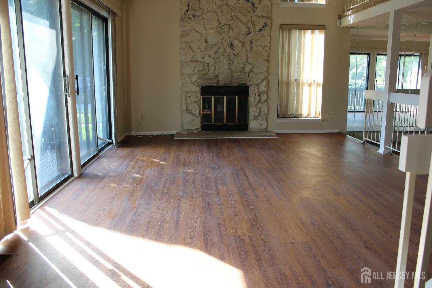 157 Westgate Drive Edison, NJ 08820 - Photo 3 of 40 a view of an empty room with wooden floor and a window