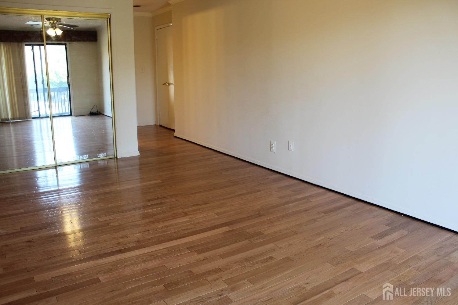 157 Westgate Drive Edison, NJ 08820 - Photo 32 of 40 a view of empty room with wooden floor and fan