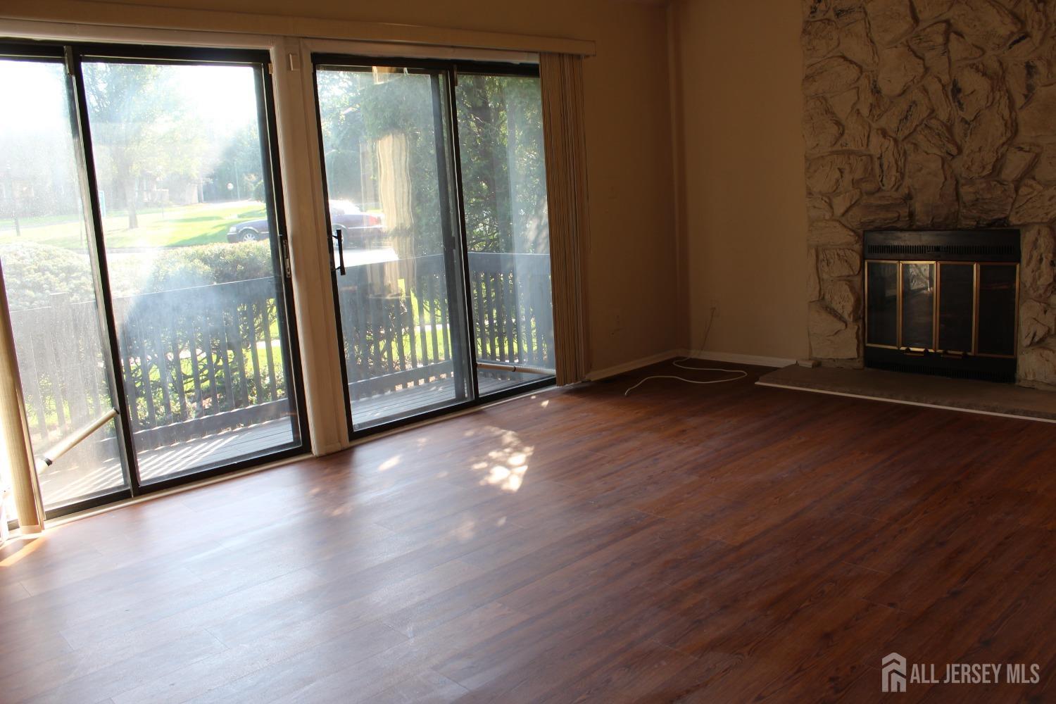 157 Westgate Drive Edison, NJ 08820 - Photo 36 of 40 a view of a room with wooden floor and a floor to ceiling window