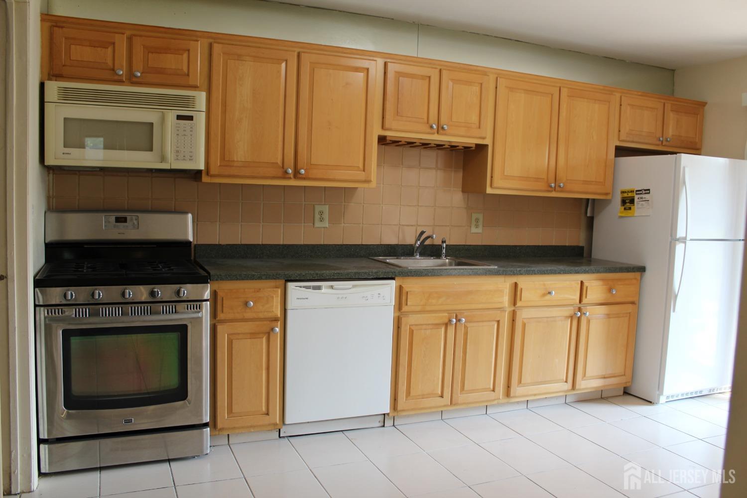 157 Westgate Drive Edison, NJ 08820 - Photo 6 of 40 a kitchen with granite countertop cabinets stainless steel appliances and a sink