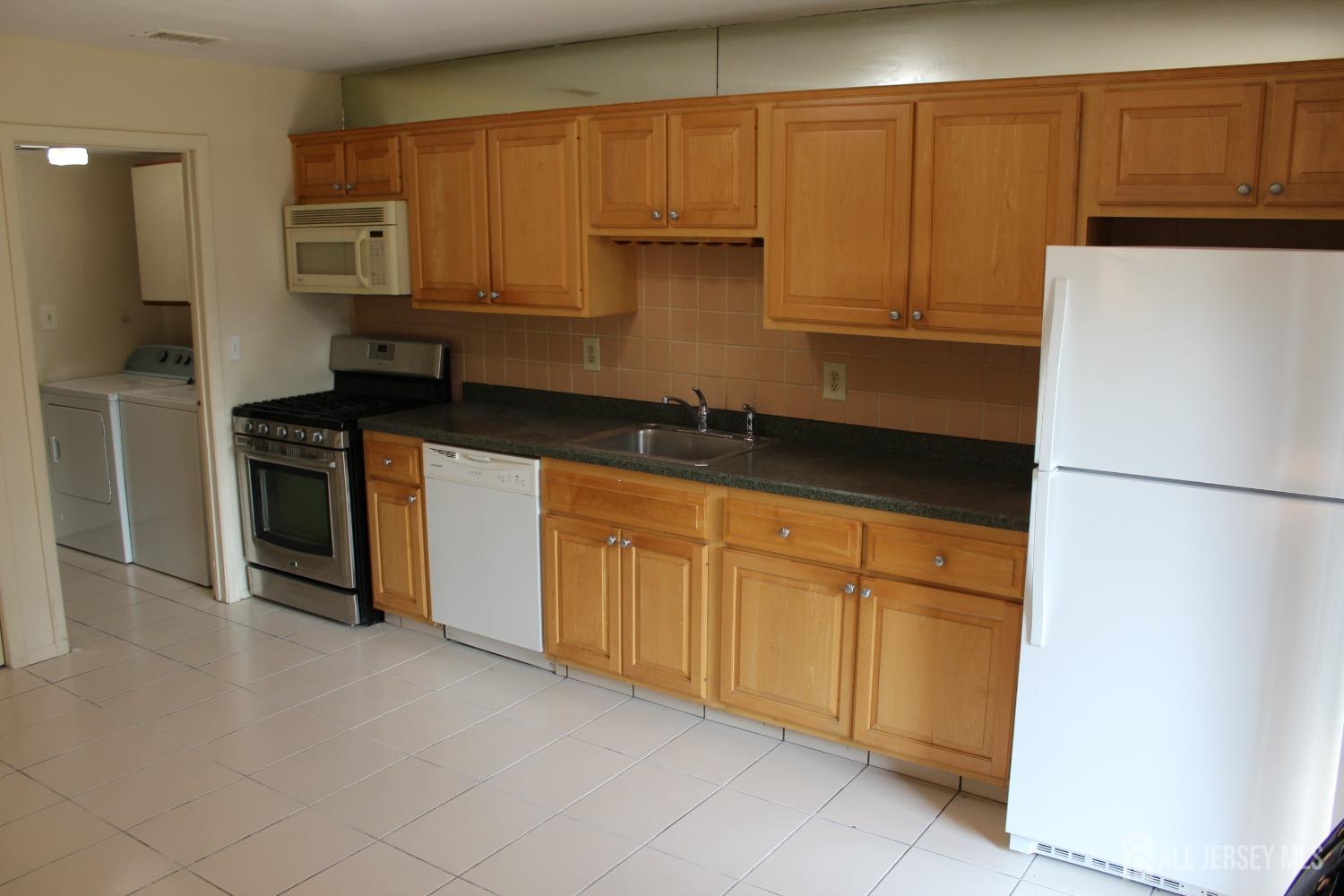157 Westgate Drive Edison, NJ 08820 - Photo 7 of 40 a kitchen with granite countertop cabinets stainless steel appliances and a counter space