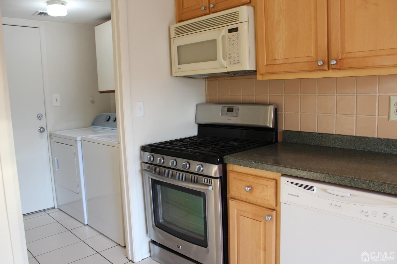 157 Westgate Drive Edison, NJ 08820 - Photo 8 of 40 a kitchen with a stove and a microwave