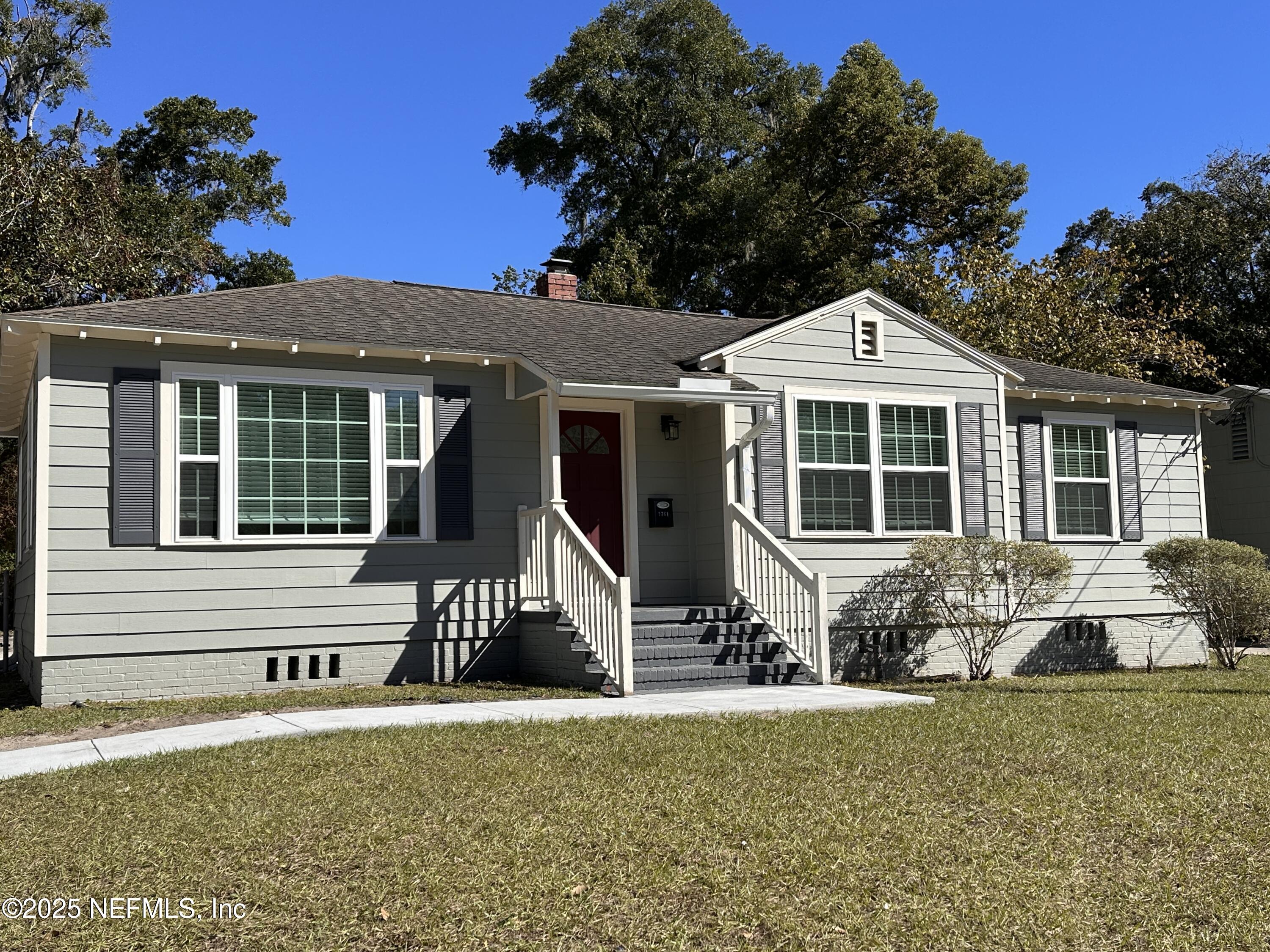a front view of a house with a garden