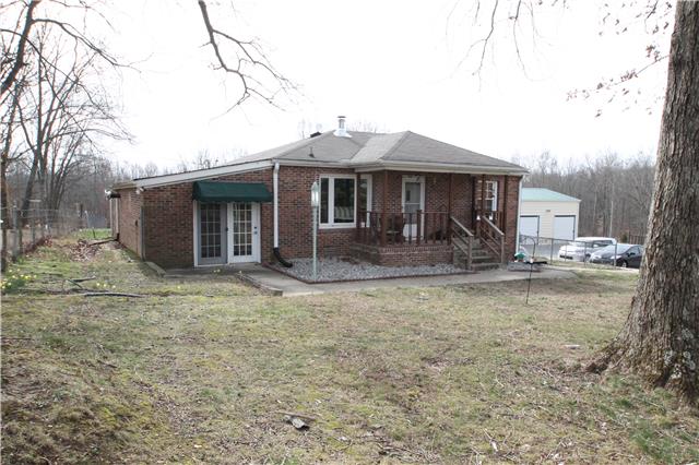 7470 Shoals Branch Road Primm Springs, TN 38476 - Photo 1 of 12 a front view of a house with garden
