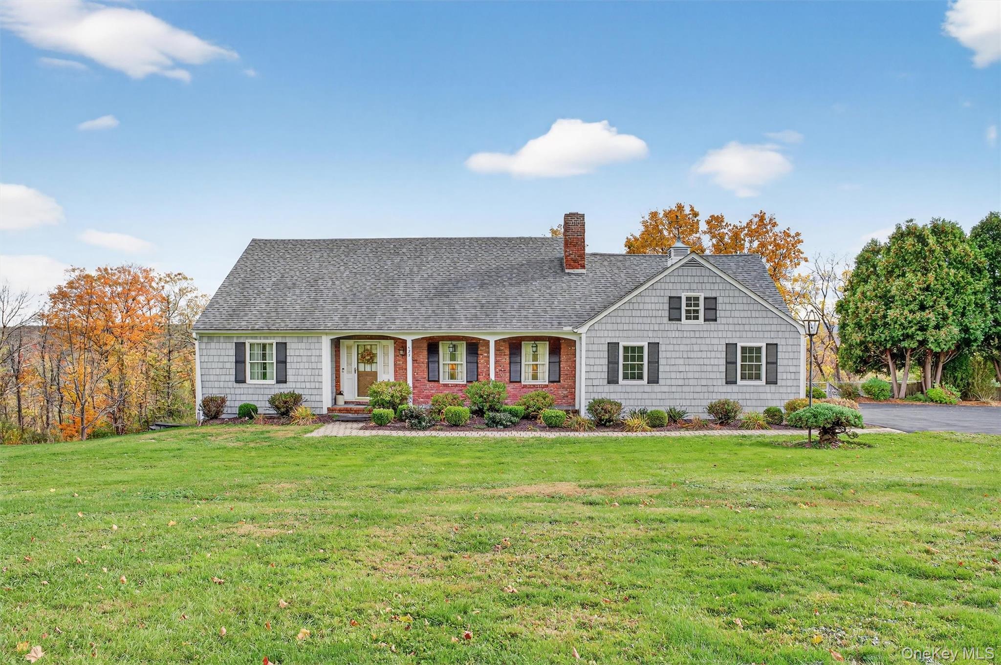 522 Ridge Road Westtown, NY 10998 - Photo 1 of 1 View of front facade featuring covered porch, a front lawn, a chimney, and roof with shingles