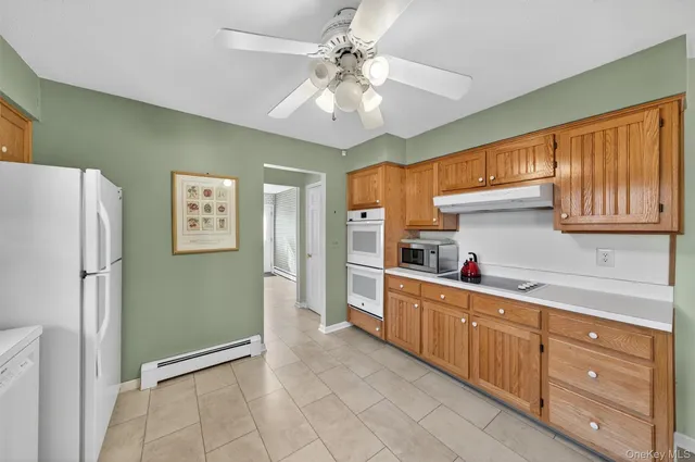 a kitchen with granite countertop a refrigerator and a sink