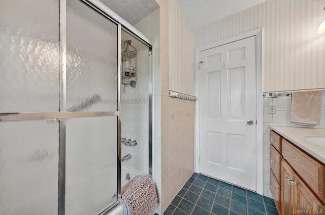 a bathroom with a shower and a sink