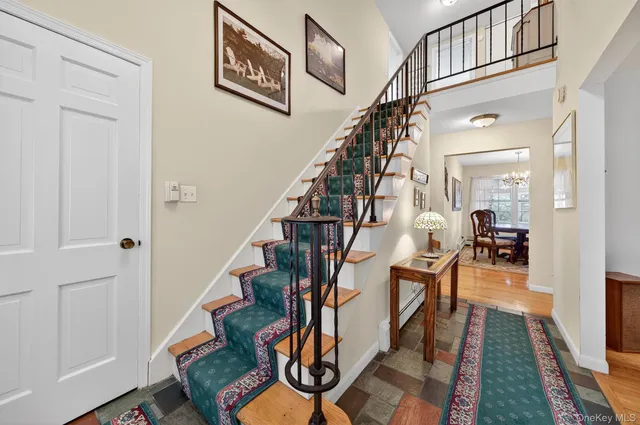 a view of entryway and hall with wooden floor