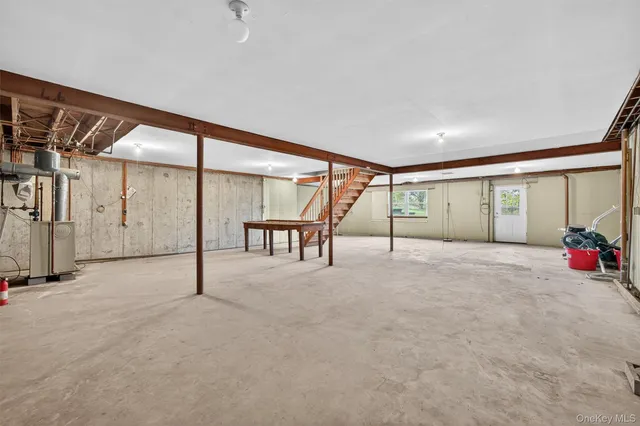 a view of a livingroom with furniture and a large window