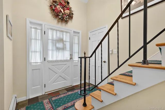 a view of entryway with wooden floor and stairs