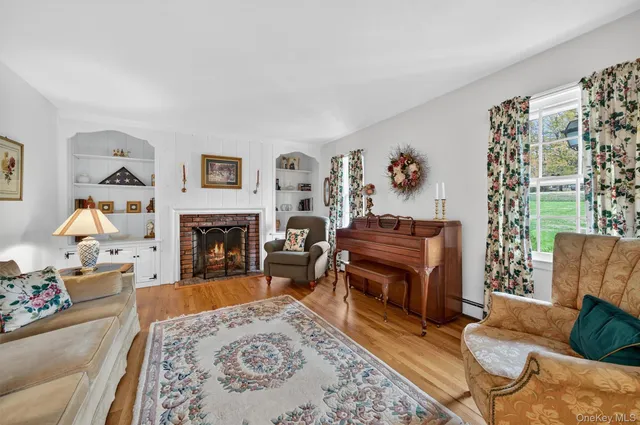 a living room with furniture large window and a fireplace