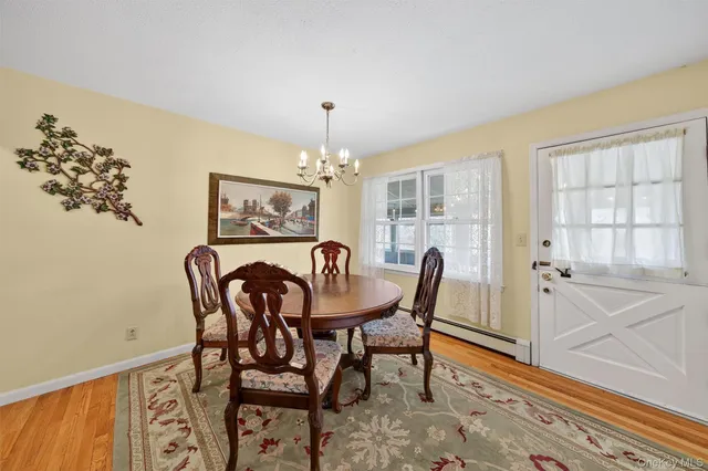 a view of a dining room with furniture and chandelier
