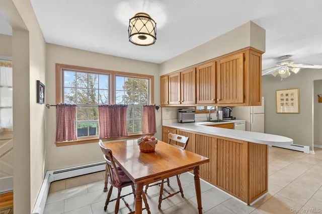 a kitchen with a large window and cabinets