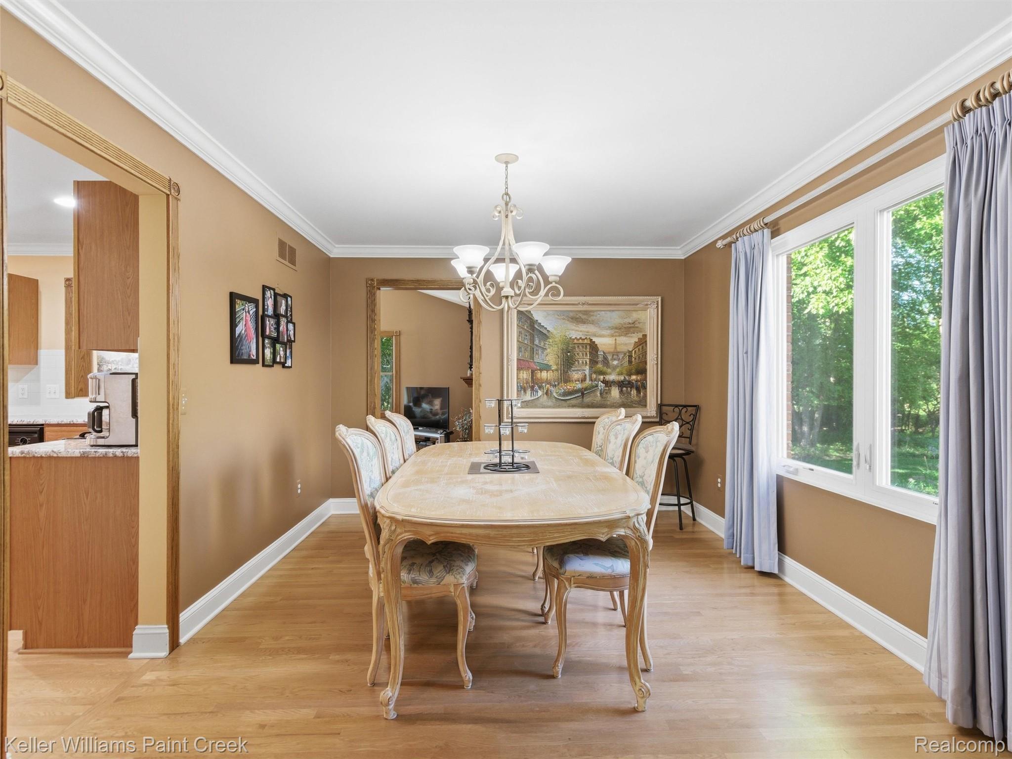 2842 Manorwood Road Troy, MI 48085 - Photo 26 of 72 Hardwood flooring extends throughout this room, featuring neutral wall tones and white crown molding