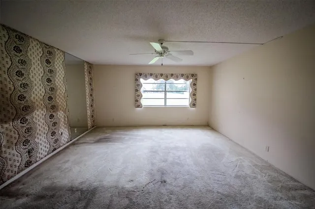 an empty room with windows and closet