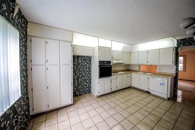 a kitchen with cabinets and white stainless steel appliances