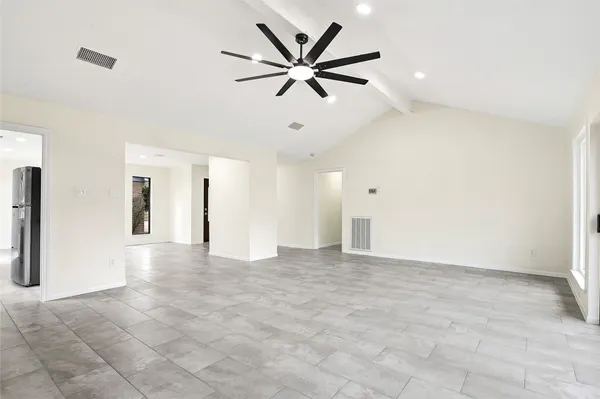 a view of an empty room with a ceiling fan