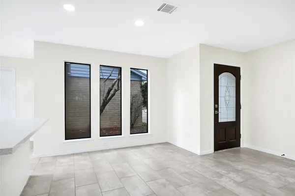 an empty room with windows and closet